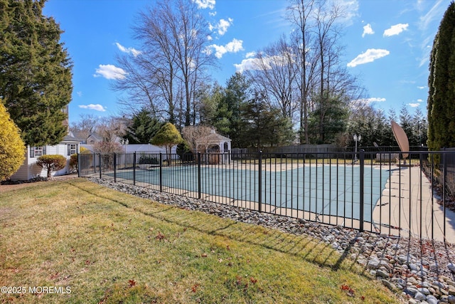 view of swimming pool featuring a patio area, a fenced in pool, fence, and a lawn