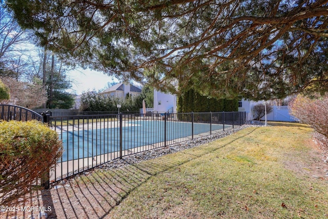 view of pool with a lawn, a patio area, fence, and a fenced in pool