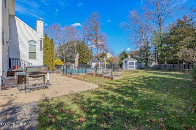 view of yard with a fenced backyard, a vegetable garden, a gazebo, and a patio