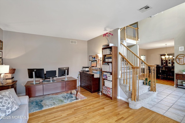 office featuring a chandelier, visible vents, and wood finished floors