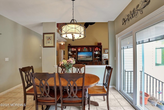 dining room featuring light tile patterned floors, baseboards, and an inviting chandelier