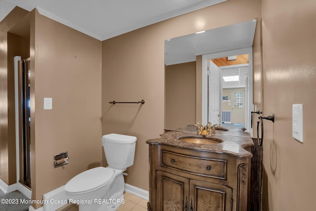 bathroom featuring toilet, ornamental molding, vanity, baseboards, and tile patterned floors