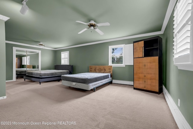 bedroom featuring baseboards, crown molding, a baseboard heating unit, and carpet flooring