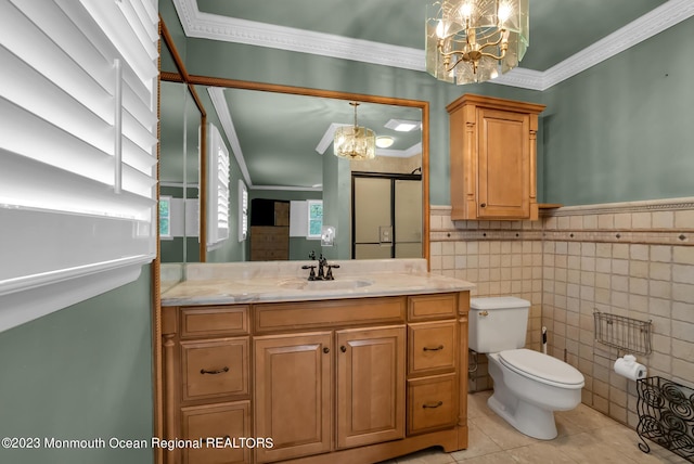 bathroom featuring wainscoting, toilet, crown molding, vanity, and a notable chandelier