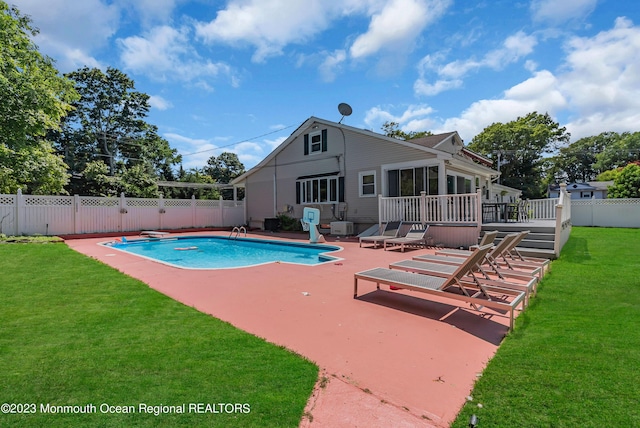 view of swimming pool with a fenced in pool, a lawn, a sunroom, a fenced backyard, and a patio area