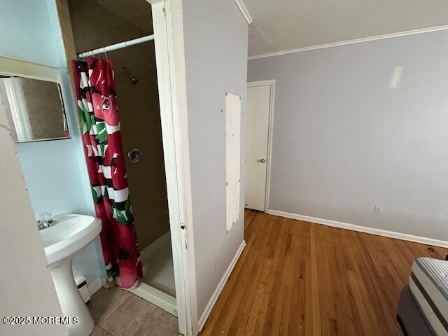 32 Cooper Ave, West Long Branch, NJ 07764 - bathroom with baseboards, ornamental molding, wood finished floors, and a shower stall