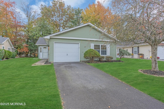 view of front of house with a front lawn, an attached garage, and aphalt driveway