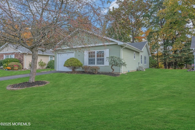 view of front of home with driveway, a front lawn, and an attached garage