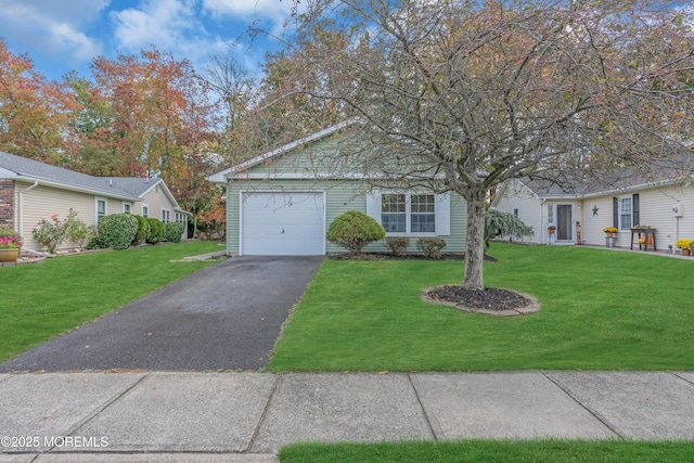 ranch-style house featuring driveway, an attached garage, and a front lawn