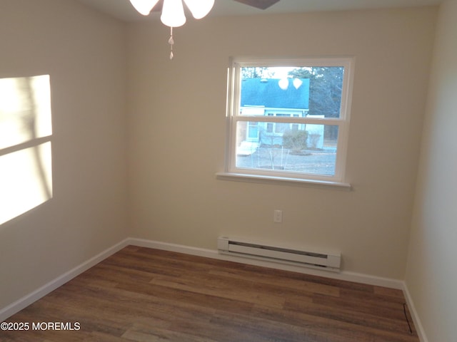 unfurnished room featuring a ceiling fan, a baseboard radiator, baseboards, and wood finished floors