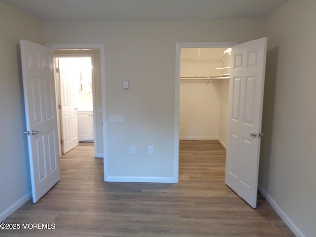 unfurnished bedroom featuring baseboards and wood finished floors