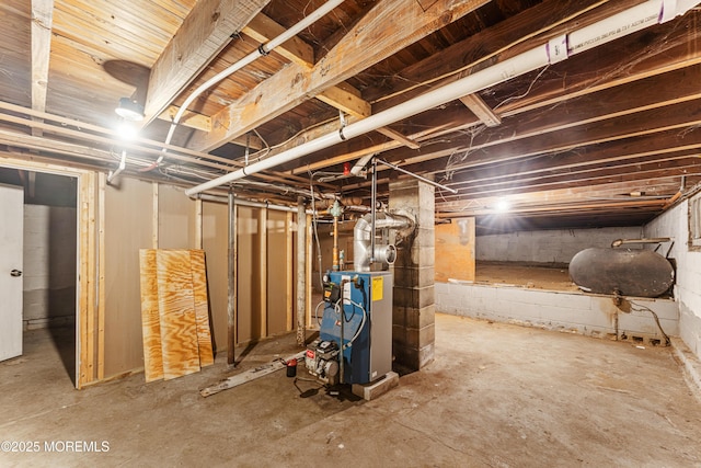 unfinished below grade area featuring a heating unit