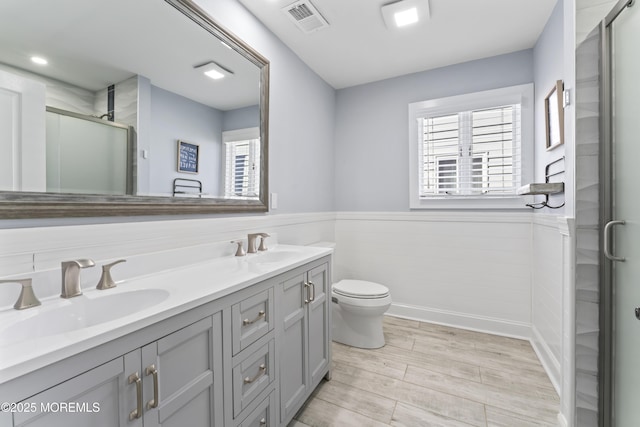45 Royal Dr, Brick, NJ 08723 - bathroom with a shower stall, double vanity, wainscoting, and wood finished floors