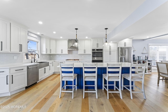 45 Royal Dr, Brick, NJ 08723 - kitchen featuring stainless steel appliances, wall chimney exhaust hood, white cabinetry, a kitchen island, and recessed lighting