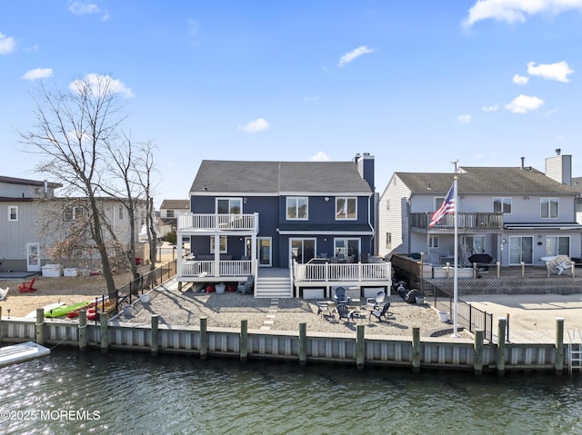 45 Royal Dr, Brick, NJ 08723 - rear view of house with a balcony, a deck with water view, a chimney, and a residential view
