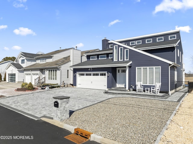 view of front of house featuring a chimney, concrete driveway, and a garage