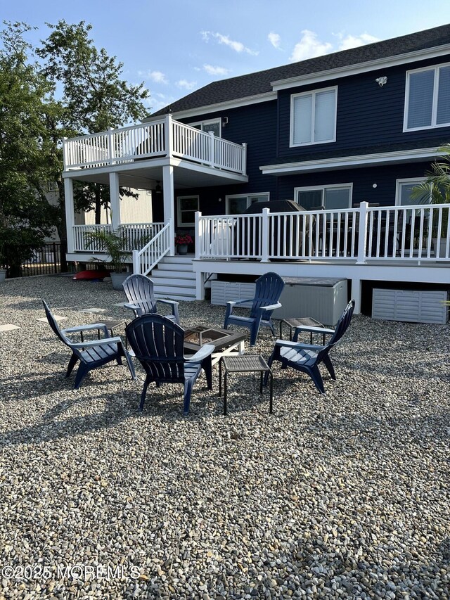 45 Royal Dr, Brick, NJ 08723 - back of house with an outdoor fire pit, a wooden deck, and a shingled roof