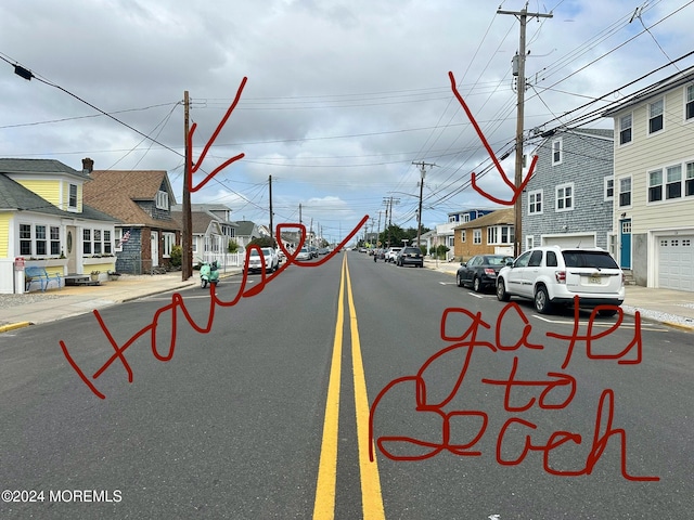 view of road featuring sidewalks, a residential view, and curbs