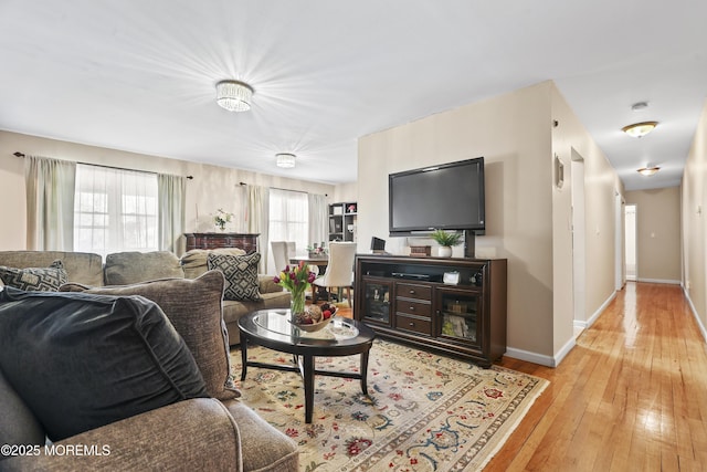 living room featuring light wood finished floors and baseboards