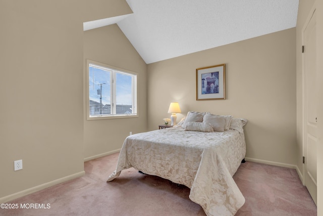 carpeted bedroom featuring lofted ceiling and baseboards