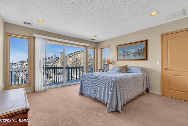 carpeted bedroom featuring a textured ceiling, access to outside, visible vents, and baseboards