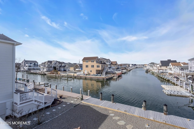 view of water feature with a boat dock and a residential view