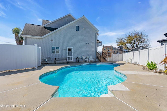 view of swimming pool with a fenced in pool, a fenced backyard, and a patio