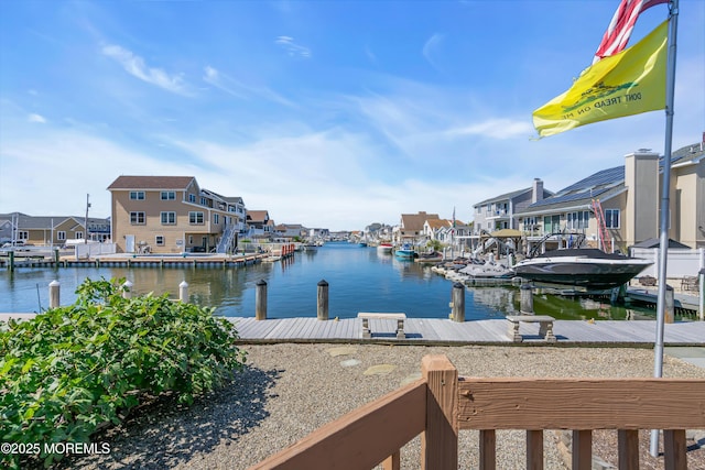 view of dock featuring a water view and a residential view