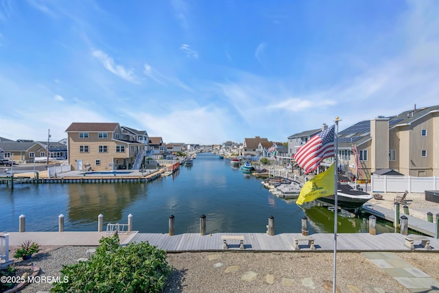 dock area featuring a water view and a residential view