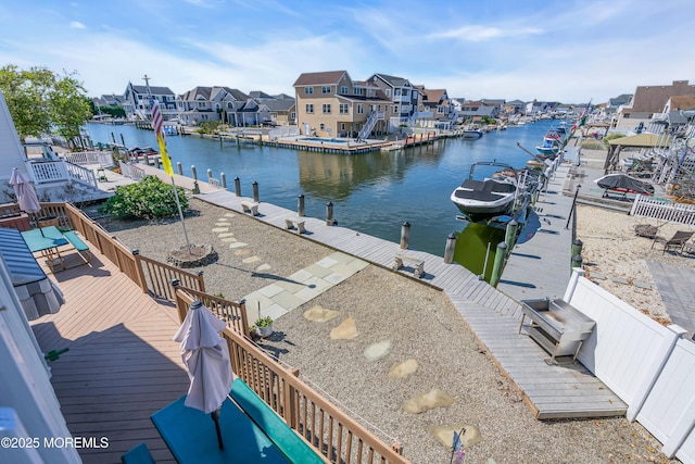 view of water feature featuring a dock and a residential view