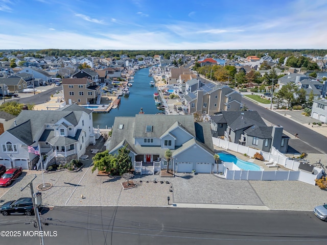 bird's eye view featuring a water view and a residential view