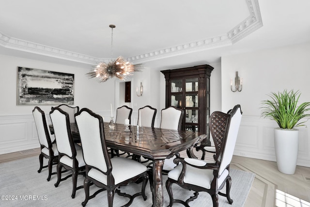 dining room with a wainscoted wall, a decorative wall, and a notable chandelier