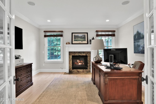 office area with a healthy amount of sunlight, a fireplace, and ornamental molding