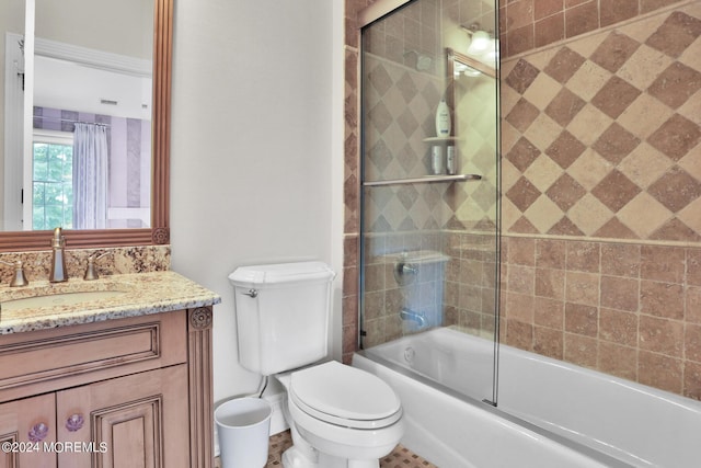 bathroom featuring toilet, enclosed tub / shower combo, and vanity