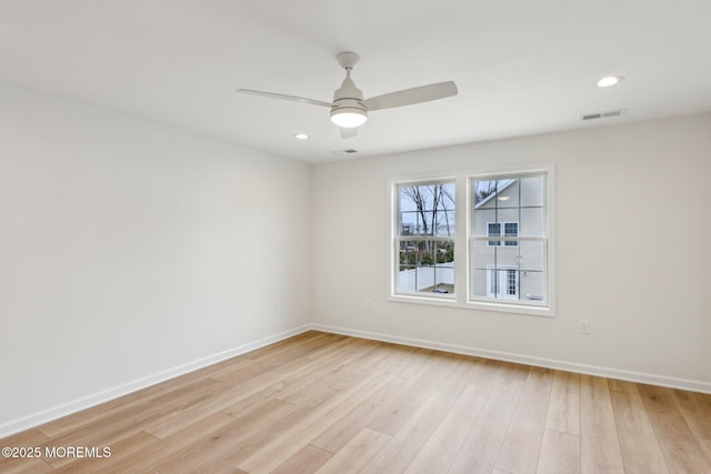 spare room with light wood finished floors, recessed lighting, visible vents, ceiling fan, and baseboards