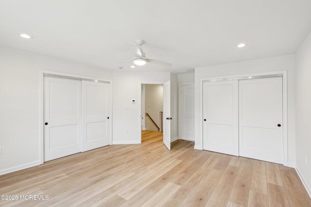 unfurnished bedroom with light wood finished floors, two closets, recessed lighting, ceiling fan, and baseboards