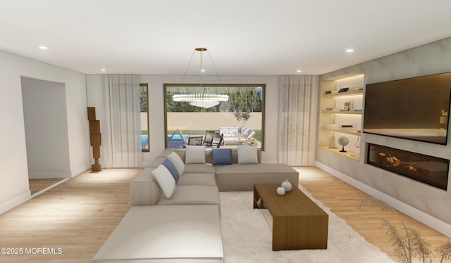 living area featuring baseboards, built in features, a glass covered fireplace, light wood-type flooring, and recessed lighting