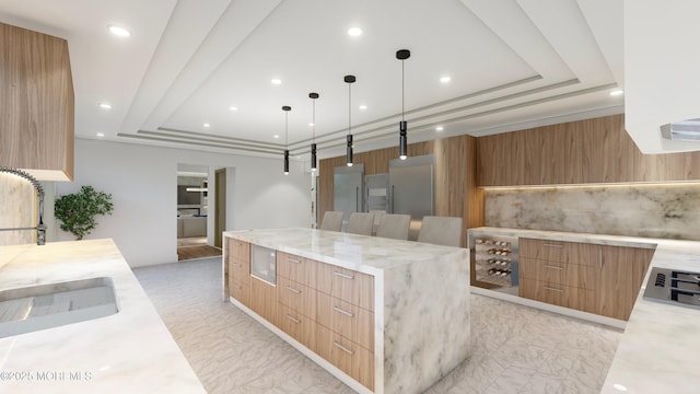 kitchen featuring light stone counters, marble finish floor, a large island, a raised ceiling, and modern cabinets