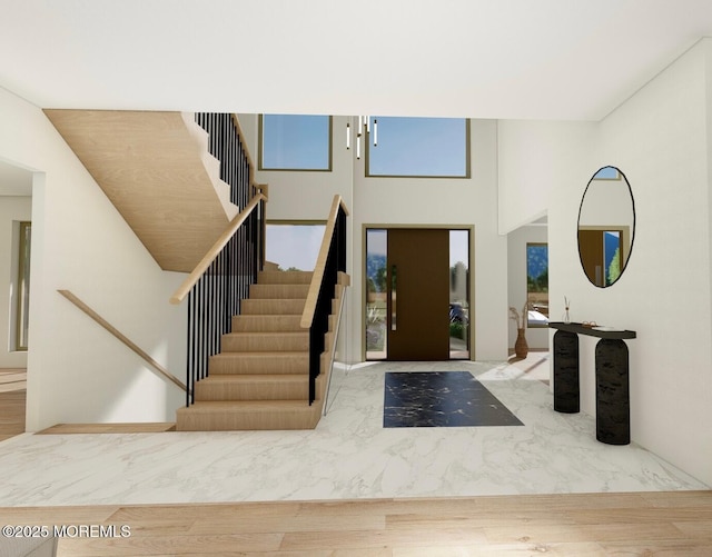 foyer entrance with stairway and wood finished floors