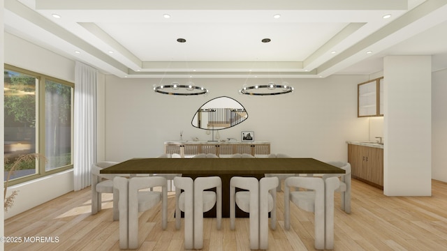 dining room featuring light wood-style floors, a tray ceiling, and recessed lighting