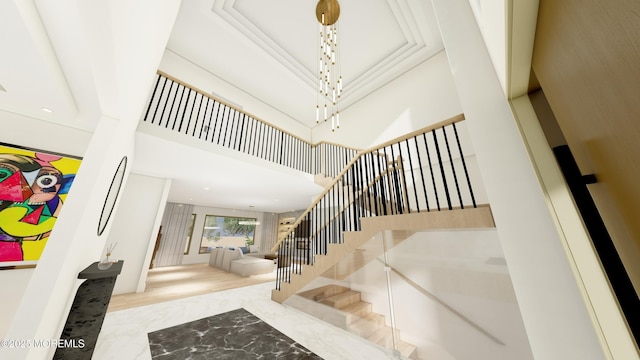 staircase featuring a chandelier and a towering ceiling