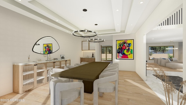 dining room featuring light wood-style flooring, a raised ceiling, and recessed lighting