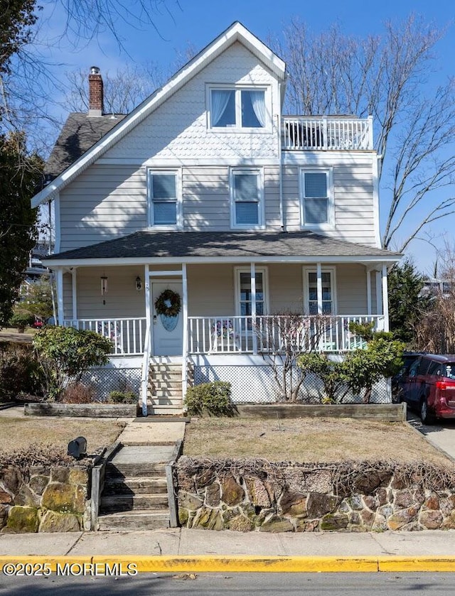 view of front of home with a porch and a balcony