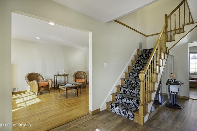 stairs with recessed lighting, visible vents, baseboards, and wood finished floors