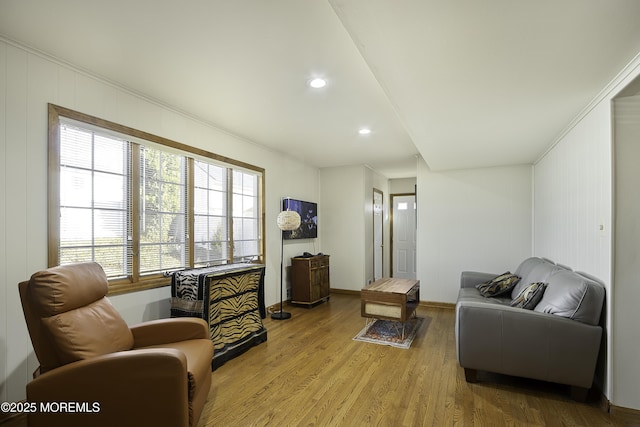 living area with recessed lighting, wood finished floors, and baseboards