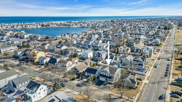 drone / aerial view with a water view and a residential view