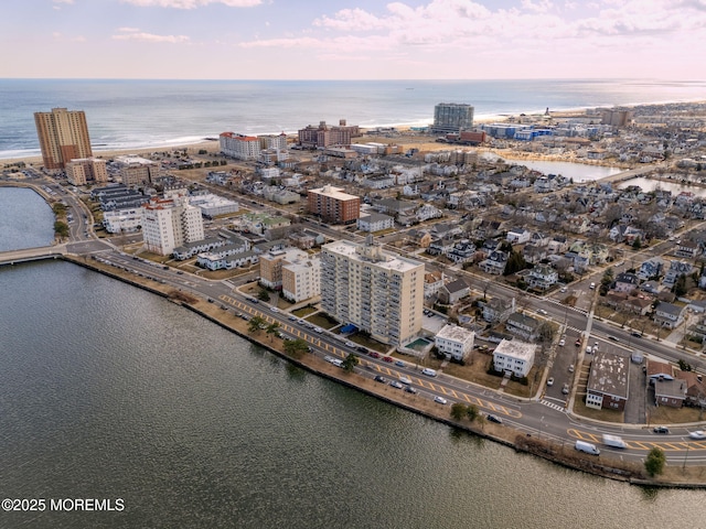 drone / aerial view featuring a water view and a view of city