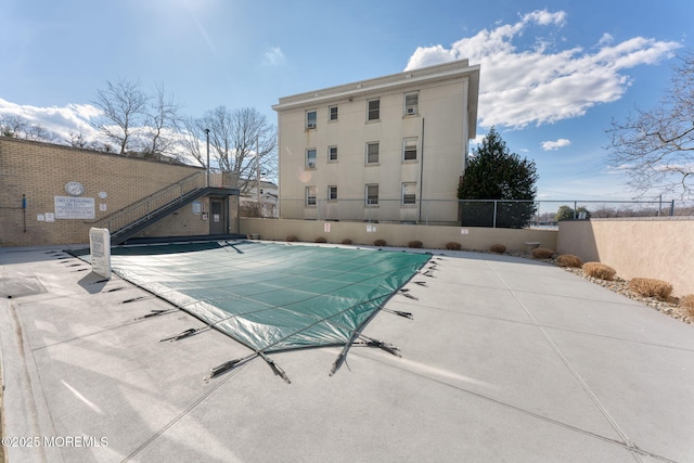 pool with fence and a patio