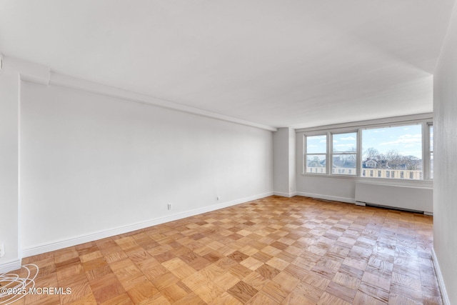 unfurnished room featuring baseboards