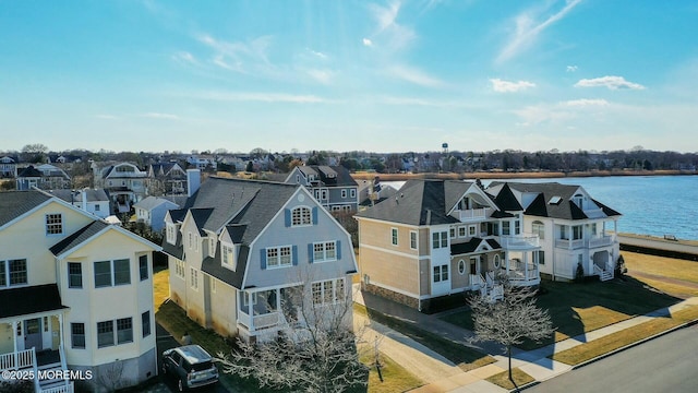 birds eye view of property featuring a residential view and a water view